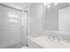 Bathroom featuring subway tile, a glass shower, and a quartz countertop at 7221 Westwind Dr, Port Richey, FL 34668