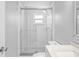 Bright bathroom featuring subway tile, a glass shower, and a quartz countertop at 7221 Westwind Dr, Port Richey, FL 34668