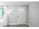 Bright foyer features a white door with glass accents, light gray walls, and modern flooring at 7221 Westwind Dr, Port Richey, FL 34668
