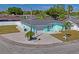 Turquoise home with a spacious driveway, well-kept lawn, and mature palm trees at 7221 Westwind Dr, Port Richey, FL 34668
