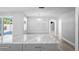 Bright renovated kitchen with a gray island, marble countertops, and hardwood floors at 7221 Westwind Dr, Port Richey, FL 34668