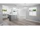 Bright renovated kitchen with a gray island, stainless steel appliances, and hardwood floors at 7221 Westwind Dr, Port Richey, FL 34668