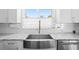 Close up of a renovated kitchen featuring white marble countertops and stainless steel appliances at 7221 Westwind Dr, Port Richey, FL 34668