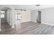 Spacious living room boasts neutral tones, modern flooring, and a sliding barn door for added style at 7221 Westwind Dr, Port Richey, FL 34668
