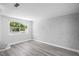 Bright living room with hardwood floors and a brick accent wall at 7221 Westwind Dr, Port Richey, FL 34668