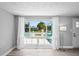 Sun-filled living room with a large window view, neutral walls, modern flooring, and stylish accents at 7221 Westwind Dr, Port Richey, FL 34668
