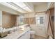 Well-lit bathroom features a vanity with ample counter space, mirror, and neutral tones at 7511 Melogold Cir, Land O Lakes, FL 34637