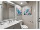 Charming half bathroom with ocean themed decor at 7511 Melogold Cir, Land O Lakes, FL 34637