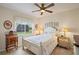 Comfortable bedroom with a window overlooking the yard, filled with natural light and cozy decor at 7511 Melogold Cir, Land O Lakes, FL 34637