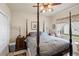 Comfortable bedroom featuring a four-poster bed, natural light, and neutral decor at 7511 Melogold Cir, Land O Lakes, FL 34637