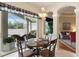 Cozy dining area featuring views of the lanai and an adjacent living room with comfortable seating at 7511 Melogold Cir, Land O Lakes, FL 34637