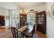 Dining area with hardwood floors, formal wood furniture, and views into the living room and front door at 7511 Melogold Cir, Land O Lakes, FL 34637