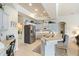 Spacious kitchen features white cabinetry, stainless steel appliances, and an eat-in bar area at 7511 Melogold Cir, Land O Lakes, FL 34637