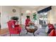 Bright living room with archways, hardwood floors, and sliding glass doors to the screened-in lanai at 7511 Melogold Cir, Land O Lakes, FL 34637