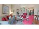 Open living room showcasing beautiful decor, hardwood floors, and seamless access to the dining room at 7511 Melogold Cir, Land O Lakes, FL 34637