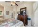 Comfortable main bedroom featuring hardwood floors, a ceiling fan, and views into the main bath at 7511 Melogold Cir, Land O Lakes, FL 34637