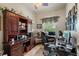 Dedicated office space equipped with built-in wooden cabinets, desk, and a comfortable work environment at 7511 Melogold Cir, Land O Lakes, FL 34637