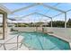 Sparkling in-ground pool with a screened enclosure, offering a refreshing escape in a private setting at 7511 Melogold Cir, Land O Lakes, FL 34637