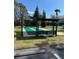 Shuffleboard court with covered seating area, providing a shaded spot to play and relax outdoors at 7511 Melogold Cir, Land O Lakes, FL 34637