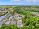 Aerial view of a neighborhood nestled amongst lush trees and waterways, perfect for nature lovers at 7925 Calindra Ct, Trinity, FL 34655