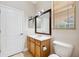 Bathroom featuring neutral tile floors, a wood vanity, a framed mirror and blinds on the window at 7925 Calindra Ct, Trinity, FL 34655