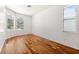 Cozy bedroom featuring hardwood floors and a window with a pool view at 7925 Calindra Ct, Trinity, FL 34655