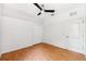 Bedroom features a ceiling fan, a large window, wood-look floors and a double door closet at 7925 Calindra Ct, Trinity, FL 34655