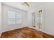 Bedroom features hardwood floors, neutral walls, and French doors at 7925 Calindra Ct, Trinity, FL 34655