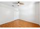 Bedroom featuring a ceiling fan, wood-look floors, white walls and a double door closet at 7925 Calindra Ct, Trinity, FL 34655