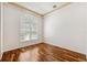 Bedroom with a stylish arched window, hardwood floors, and modern lighting at 7925 Calindra Ct, Trinity, FL 34655