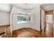 Dining room showcasing wood floors and a bay window with a view of the screened pool at 7925 Calindra Ct, Trinity, FL 34655