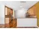Bright kitchen showcasing wood cabinetry, granite countertops, a tiled backsplash, and stainless steel appliances at 7925 Calindra Ct, Trinity, FL 34655