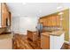 Spacious kitchen with wooden cabinets, granite countertops, stainless steel appliances, and hardwood floors at 7925 Calindra Ct, Trinity, FL 34655
