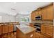 Kitchen featuring stainless steel appliances, granite countertops, island and adjacent breakfast nook at 7925 Calindra Ct, Trinity, FL 34655