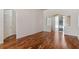 Neutral living room with wood floors, arched doorway and sliding glass doors at 7925 Calindra Ct, Trinity, FL 34655