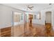 Bright living room with wood floors, ceiling fan, and sliding glass doors to the patio at 7925 Calindra Ct, Trinity, FL 34655