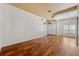 Bright living room with hardwood floors, arched window, and double-door entryway at 7925 Calindra Ct, Trinity, FL 34655