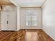 Bright, open living room with hardwood floors, a large arched window, and a view of the entryway at 7925 Calindra Ct, Trinity, FL 34655