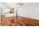 Spacious living area with wood floors, ceiling fan, and open access to the kitchen at 7925 Calindra Ct, Trinity, FL 34655