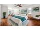 Bright main bedroom with hardwood floors, ceiling fan, and windows offering natural light at 7925 Calindra Ct, Trinity, FL 34655