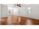 Spacious main bedroom with hardwood floors, ceiling fan, and windows offering natural light at 7925 Calindra Ct, Trinity, FL 34655