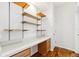 Bright office space features floating shelves, a built-in desk, and rich wood floors, perfect for a functional workspace at 7925 Calindra Ct, Trinity, FL 34655
