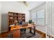 Bright home office with a built-in bookcase and natural light at 7925 Calindra Ct, Trinity, FL 34655