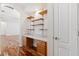 Office nook featuring a desk, drawers and shelves with wood-look floors and white walls at 7925 Calindra Ct, Trinity, FL 34655