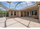 Spacious covered patio with sliding glass doors and large windows that overlooks screened-in pool at 7925 Calindra Ct, Trinity, FL 34655