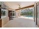 Spacious covered patio offers easy access to the pool area through large sliding glass doors at 7925 Calindra Ct, Trinity, FL 34655