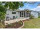 Serene backyard view featuring a screened lanai, cozy patio area, and tasteful landscaping at 9348 Villa Entrada, New Port Richey, FL 34655