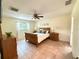 Bright bedroom features tiled floors, a ceiling fan, and a cozy sleigh bed with matching wood furniture at 9348 Villa Entrada, New Port Richey, FL 34655