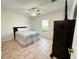 This bedroom features tiled floors, a ceiling fan, and a large window offering plenty of natural light at 9348 Villa Entrada, New Port Richey, FL 34655