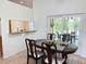 Elegant dining room featuring a classic table set with sliding door access to a screened patio at 9348 Villa Entrada, New Port Richey, FL 34655